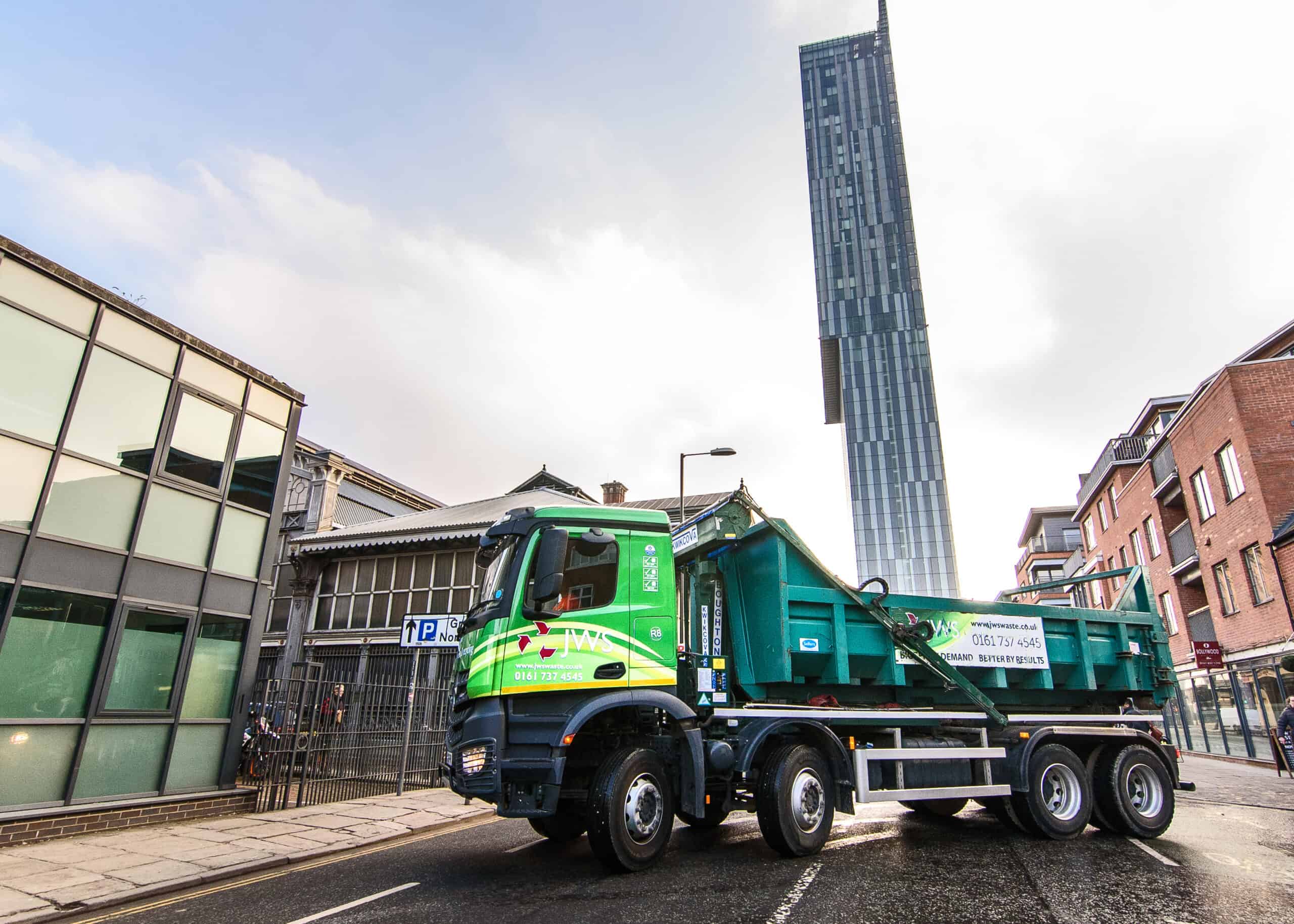 JWS Skip Hire lorry delivering to a site in Salford