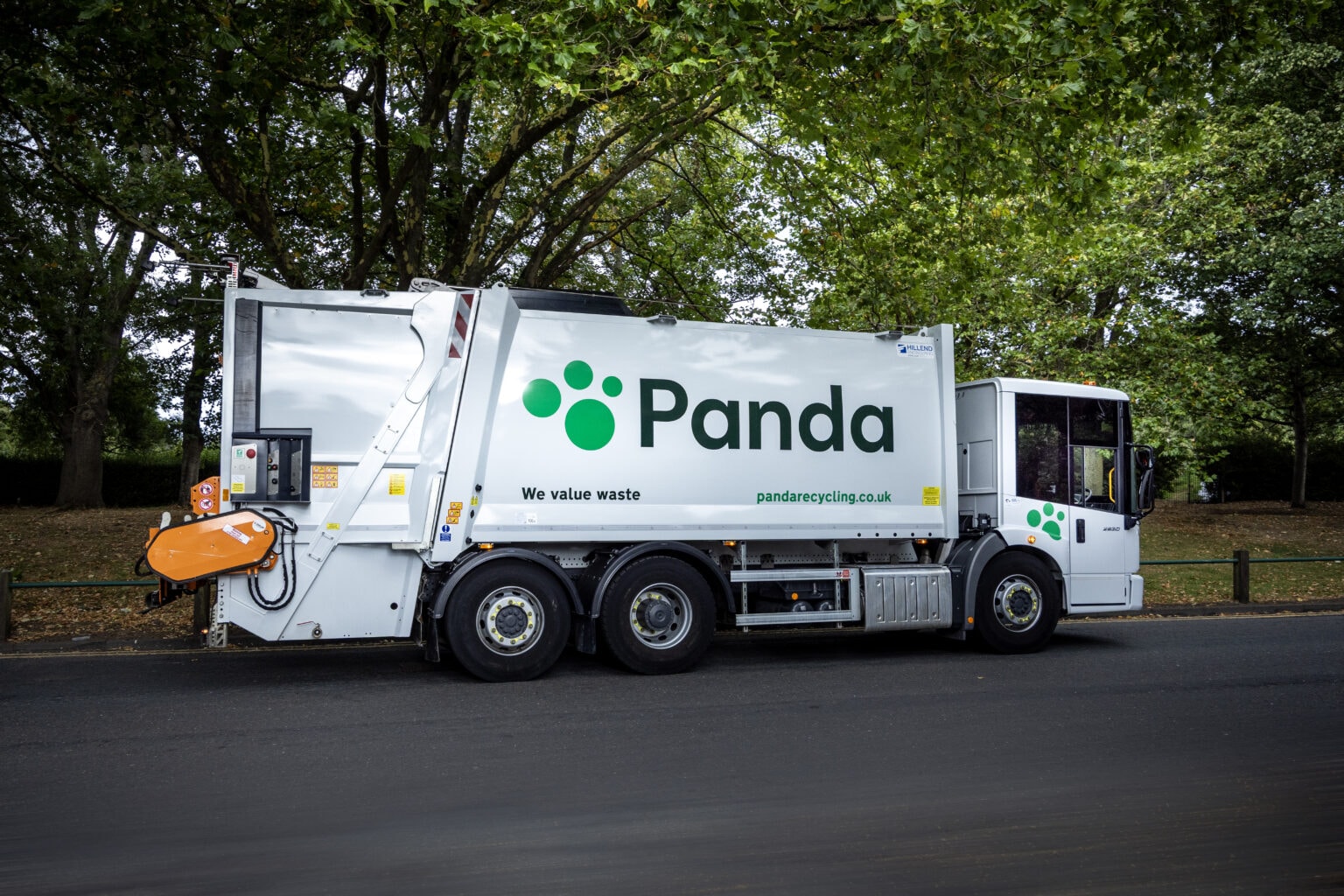 Panda lorry on leafy suburban road